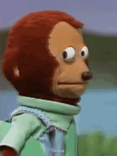 A monkey puppet looking around awkwardly